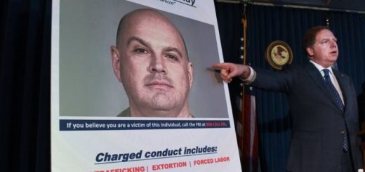 Manhattan US Attorney Geoffrey Berman points at a photo of Lawrence Ray as charges are announced in New York City in February 2020.